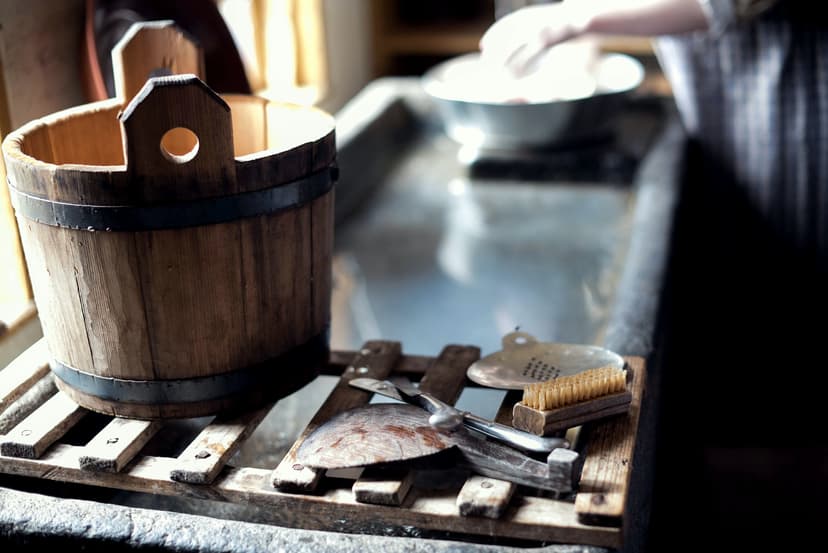 a person cleaning mould utensils with water